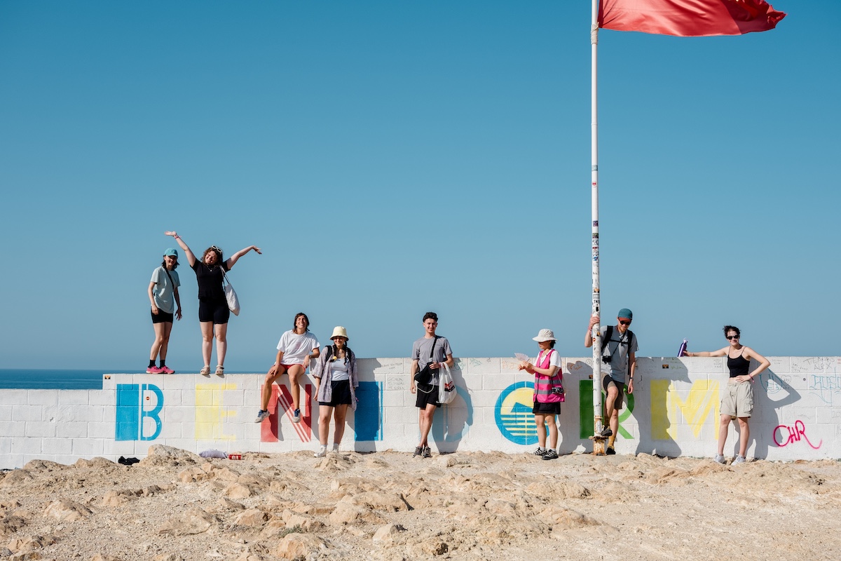 workshop participants in front of a Benidorm sign