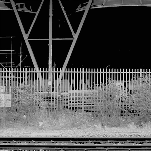 a view onto the train tracks near South Bermondsey with industrial works in the background