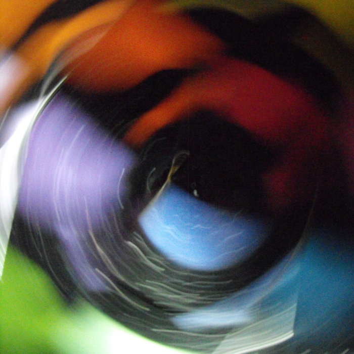 a long exposure photograph showing a blurred collection of CD cases of the release