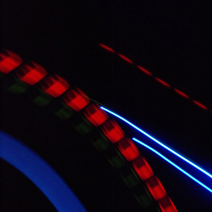 a long exposure photograph showing the reflected lights of a sample pad in a window at night