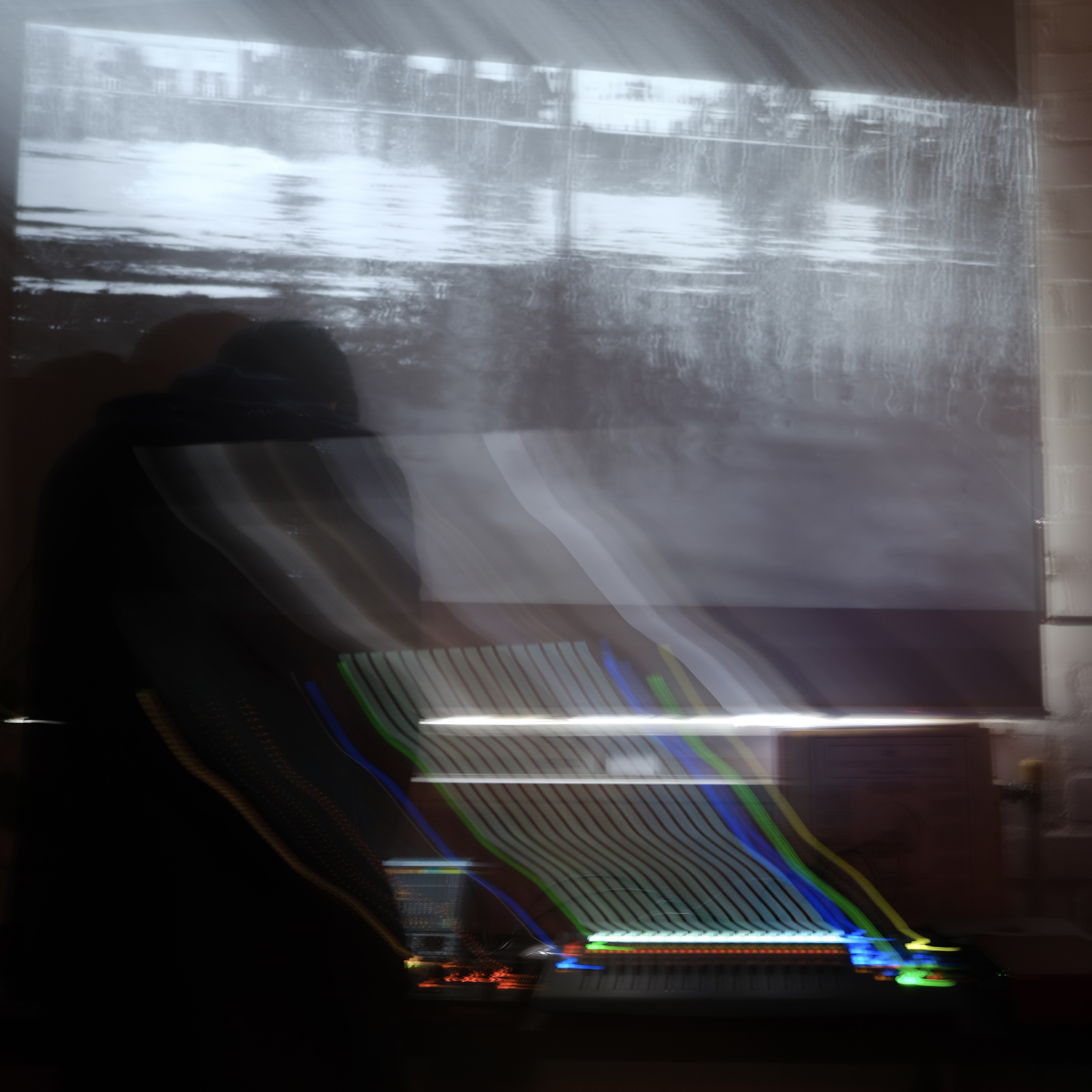 a long exposure photograph capturing 9MP's live set with Monty's visuals from the River Thames beaches