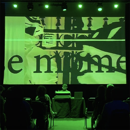 Rotem playing a modular synth in front of a projected visual