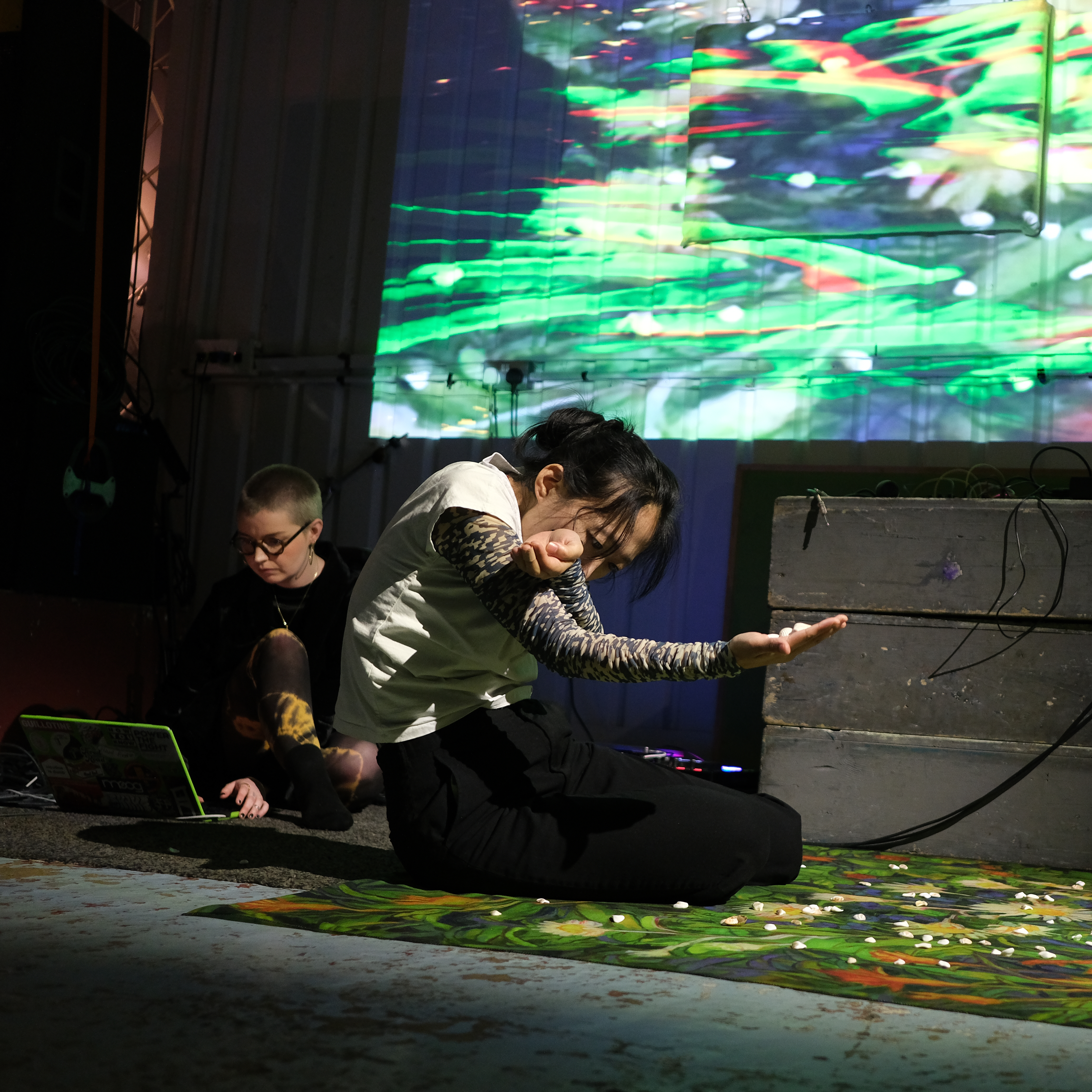 a photo from a live show featuring Yiskāh's sounds, Gao's performance art and Monty's live visuals